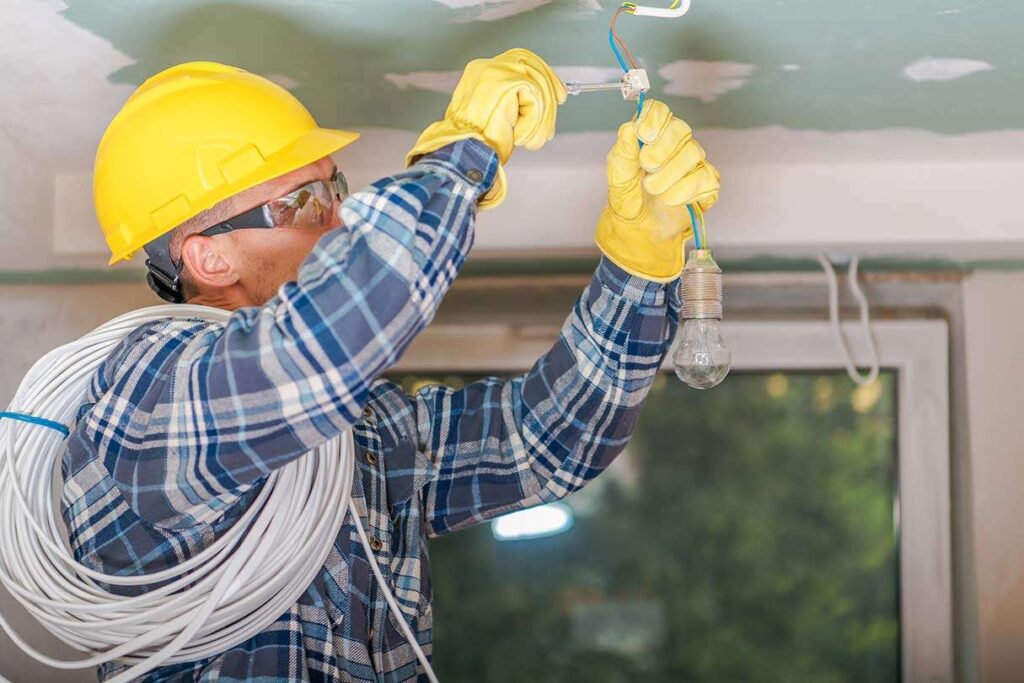 Electrician wiring up light