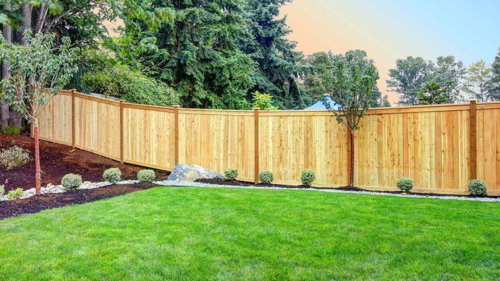 large wood fence with lawn